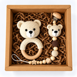 Cream handmade crochet bear rattle and matching bear pacifier holder in a kraft gift box