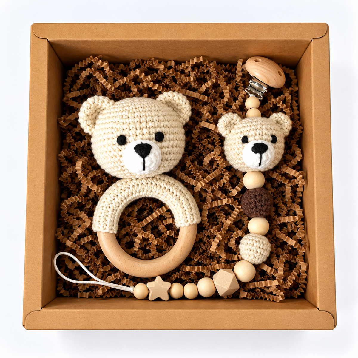 Cream handmade crochet bear rattle and matching bear pacifier holder in a kraft gift box