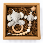 Handmade crochet elephant baby rattle and matching elephant pacifier holder in a kraft gift box