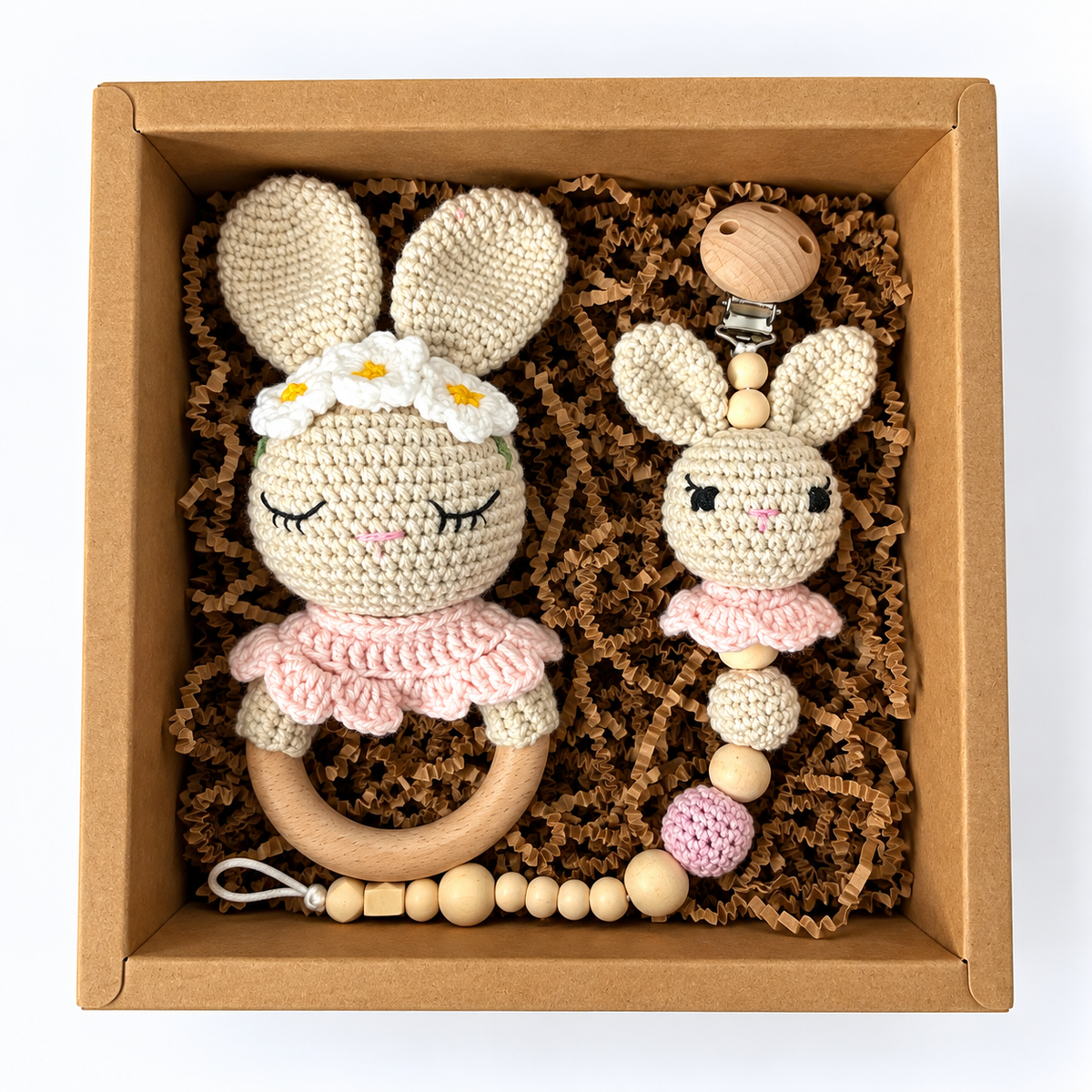 Floral bunny crochet rattle and matching bunny pacifier holder without bow, arranged in kraft gift box