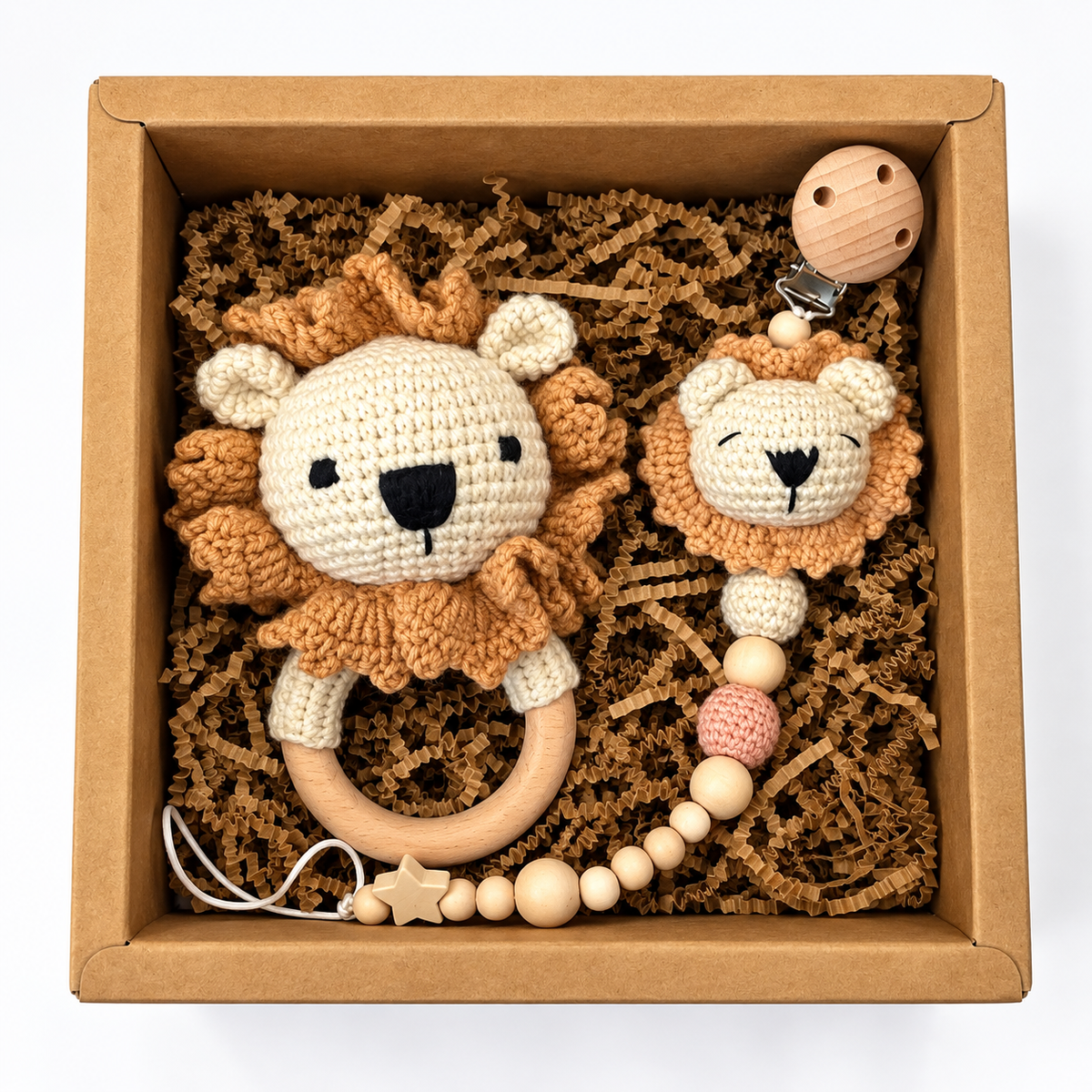 Handmade lion crochet baby rattle and matching lion pacifier holder in a kraft gift box