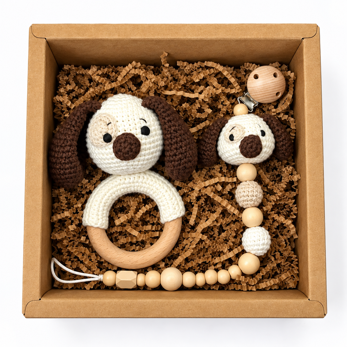 Handmade crochet puppy rattle and matching puppy pacifier holder in a kraft gift box